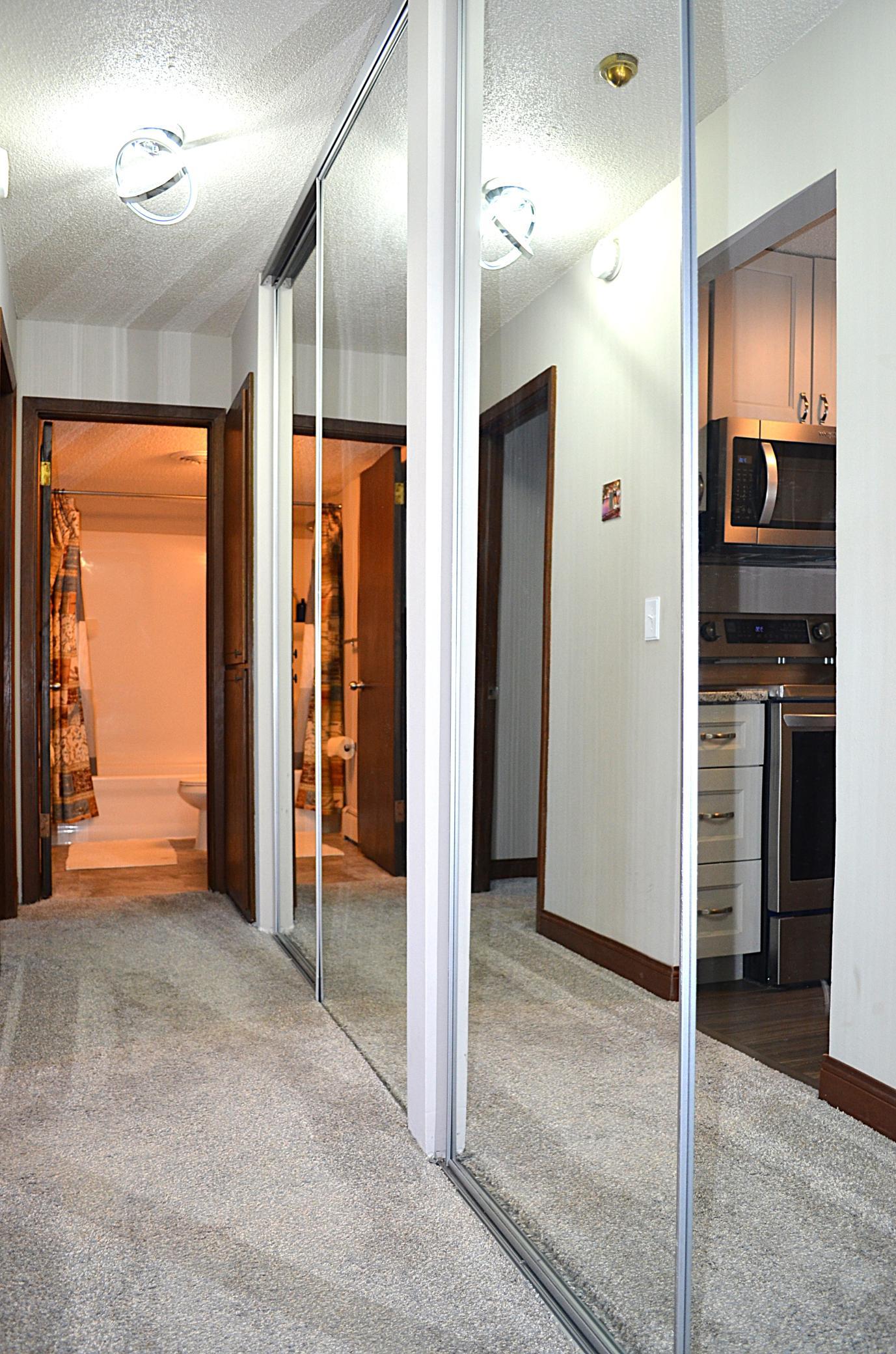 An Entire Wall of Floor to Ceiling Mirrored Closet Space