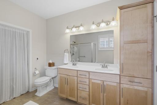 The primary bathroom pairs everyday comfort with thoughtful details, featuring dual sinks, a separate soaking tub and shower, a walk-in closet and HEATED floors for an extra touch of warmth.