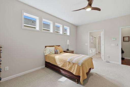 The generously sized primary bedroom offers plenty of room to comfortably accommodate a full king size bedroom set, with ample space remaining to move about with ease.