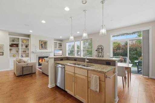 The kitchen's center island looks out toward the backyard, creating a wonderful connection to the outdoor spaces while you cook or gather. Maple cabinetry, granite countertops and stainless steel appliances add timeless style.
