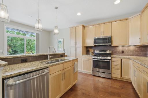 A stainless gas range and generous cabinet storage make this kitchen as practical as it is inviting, providing plenty of room for cooking, entertaining and keeping everything organized.