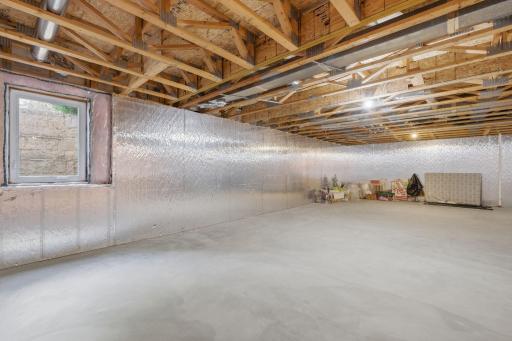 The unfinished lower level offers massive potential with room for a family room, bedroom, bath (rough-in ready), and separate storage.