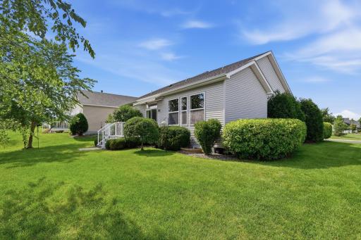 Beautifully established landscaping surrounds the home, adding natural beauty and a sense of permanence to the outdoor spaces.