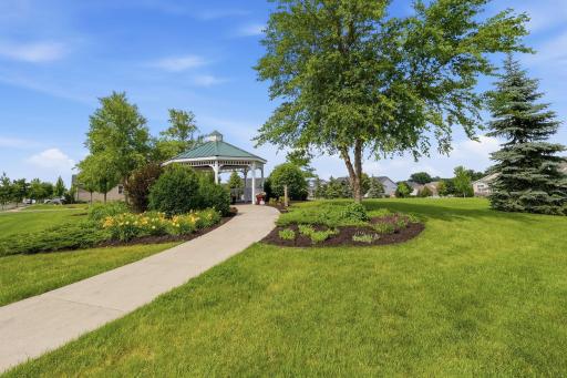 Enjoy the added appeal of a beautifully maintained green space across from the home, complete with charming gazebo.