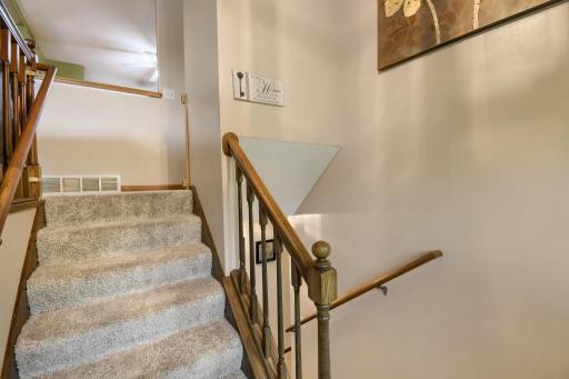 The foyer area to transition from the main level to the lower level. New carpet was recently put on the stairs.