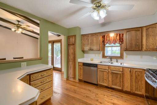 The kitchen features plenty of counter space, hardwood floors and a kitchen window overlooking the back deck and yard.