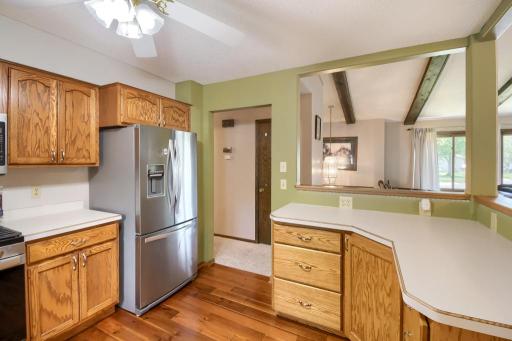 The kitchen features stainless steel appliances and plenty of cabinetry! Look out to the living and dining areas from here!