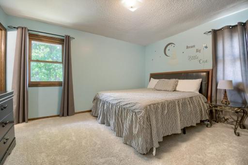 The primary bedroom overlooks the backyard and side yard. You will enjoy the attached bathroom to the primary bedroom (to the left)! Note the new carpet as well in this room.