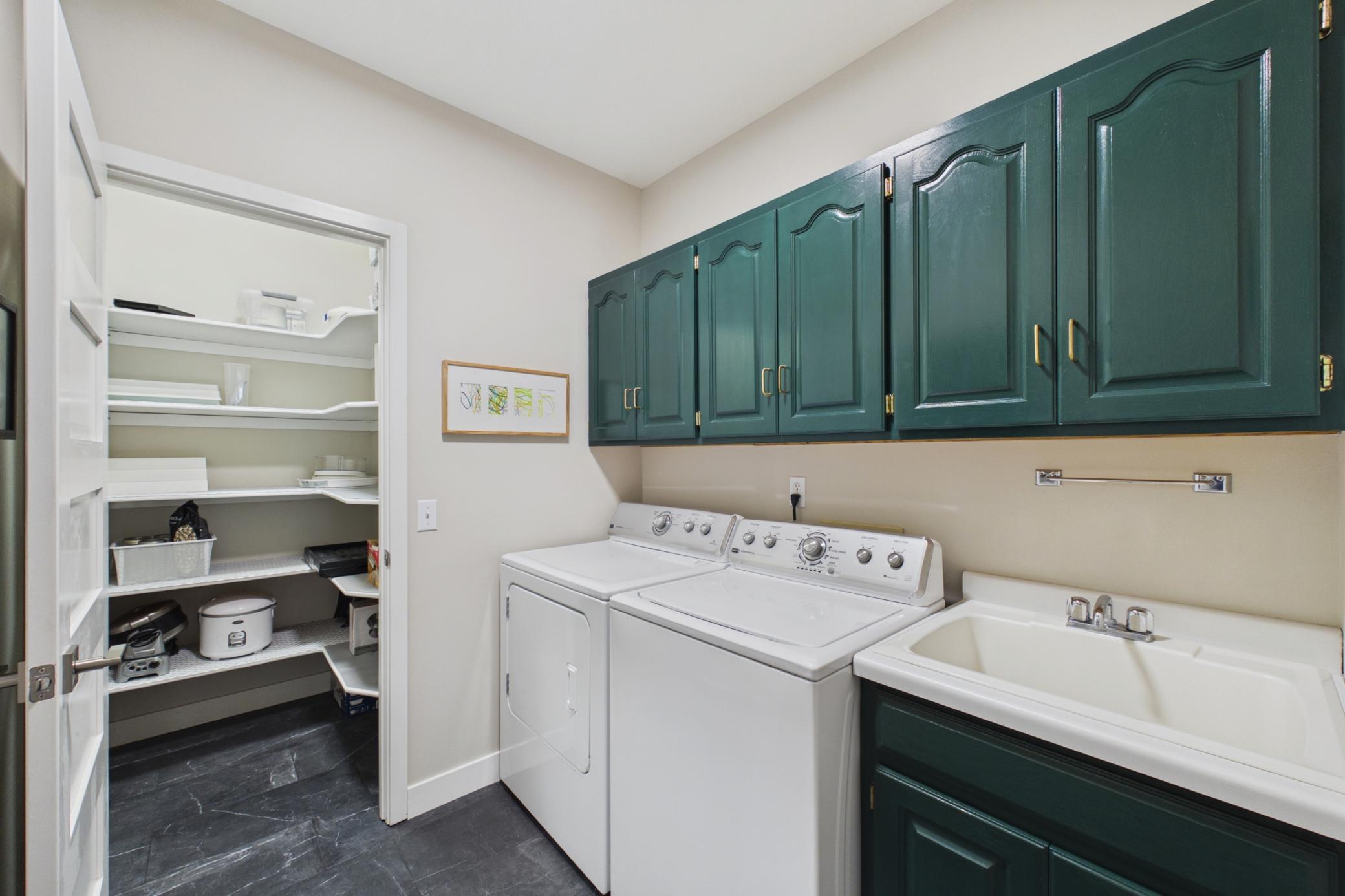 Main floor laundry with a walk in pantry!