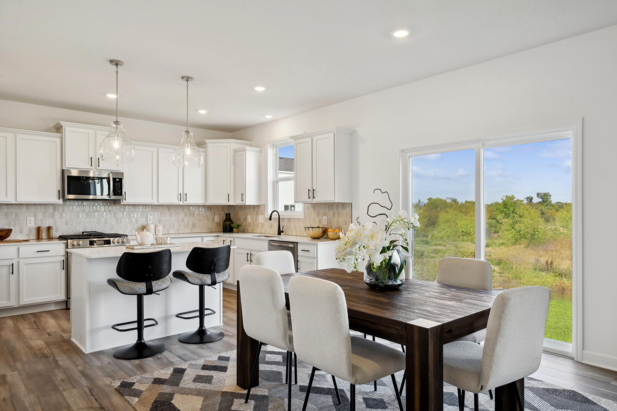 (Photo of a decorated model, actual homes finishes will vary) Located in the heart of the home, the home's eat-in kitchen.