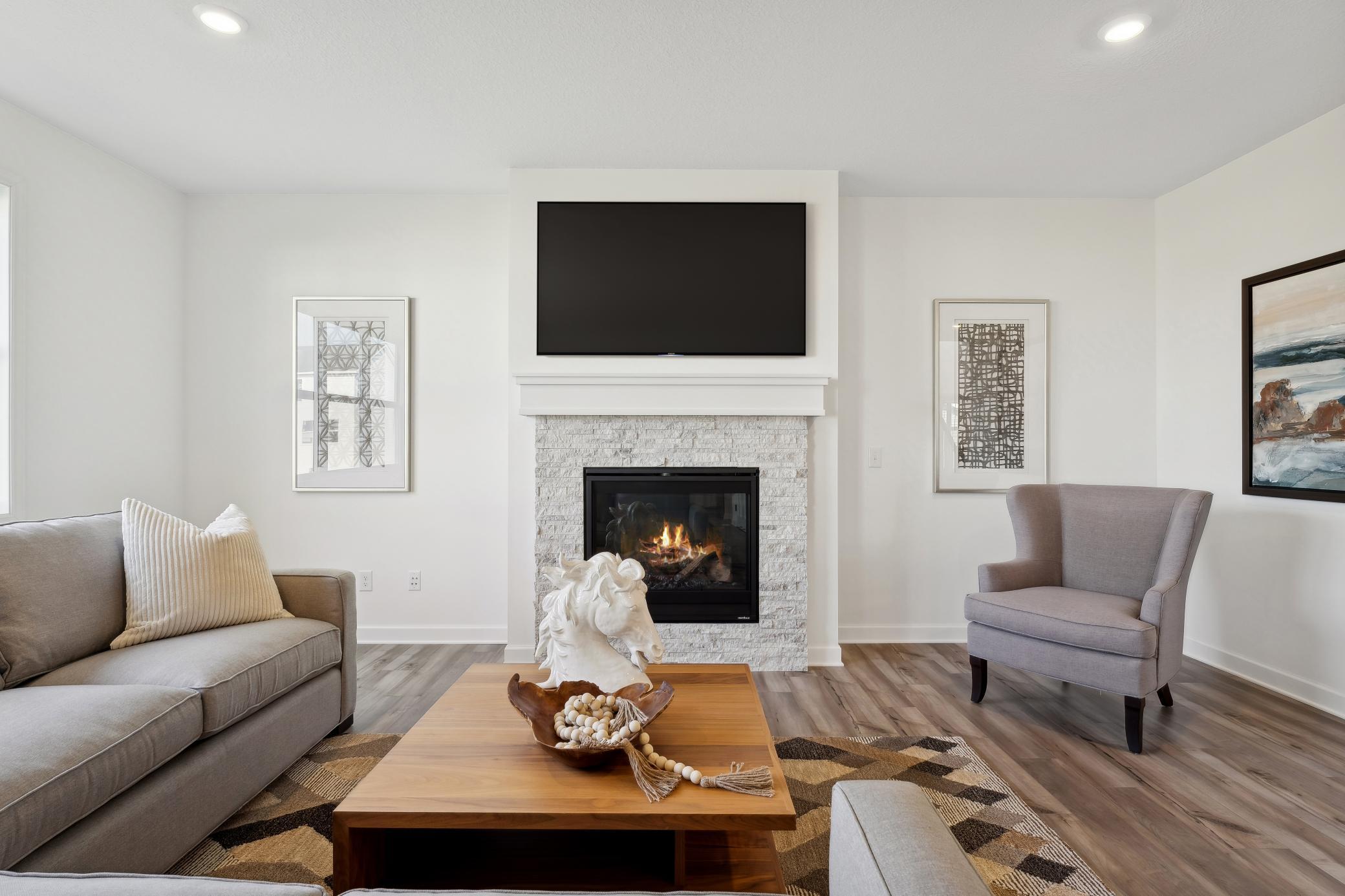 (Photo of a decorated model, actual homes finishes will vary) The stunning fireplace in the great room!