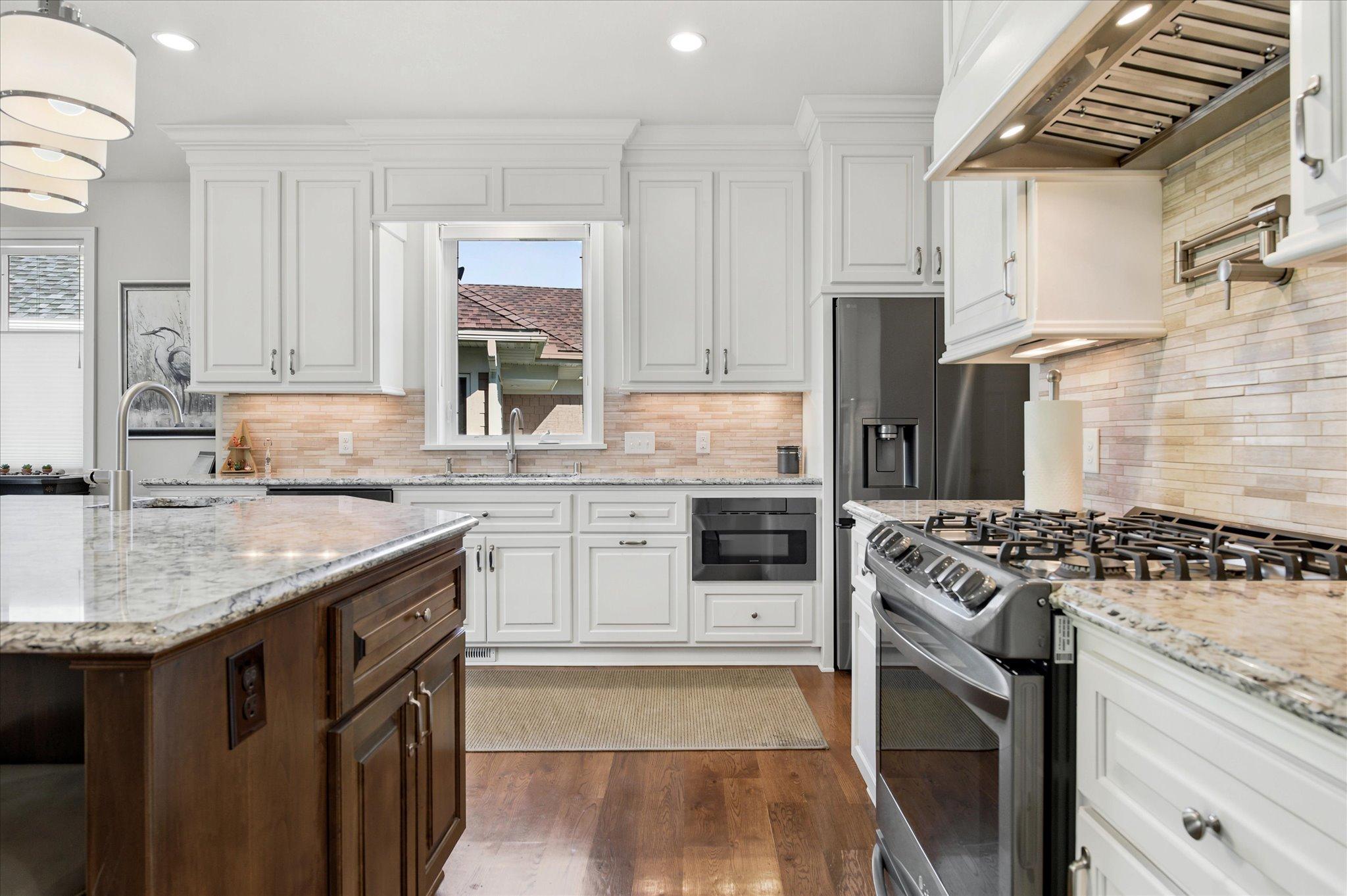 Pot filler, soft close drawers & doors, walk in pantry with pull out shelves, under cabinet lighting, beer fridge