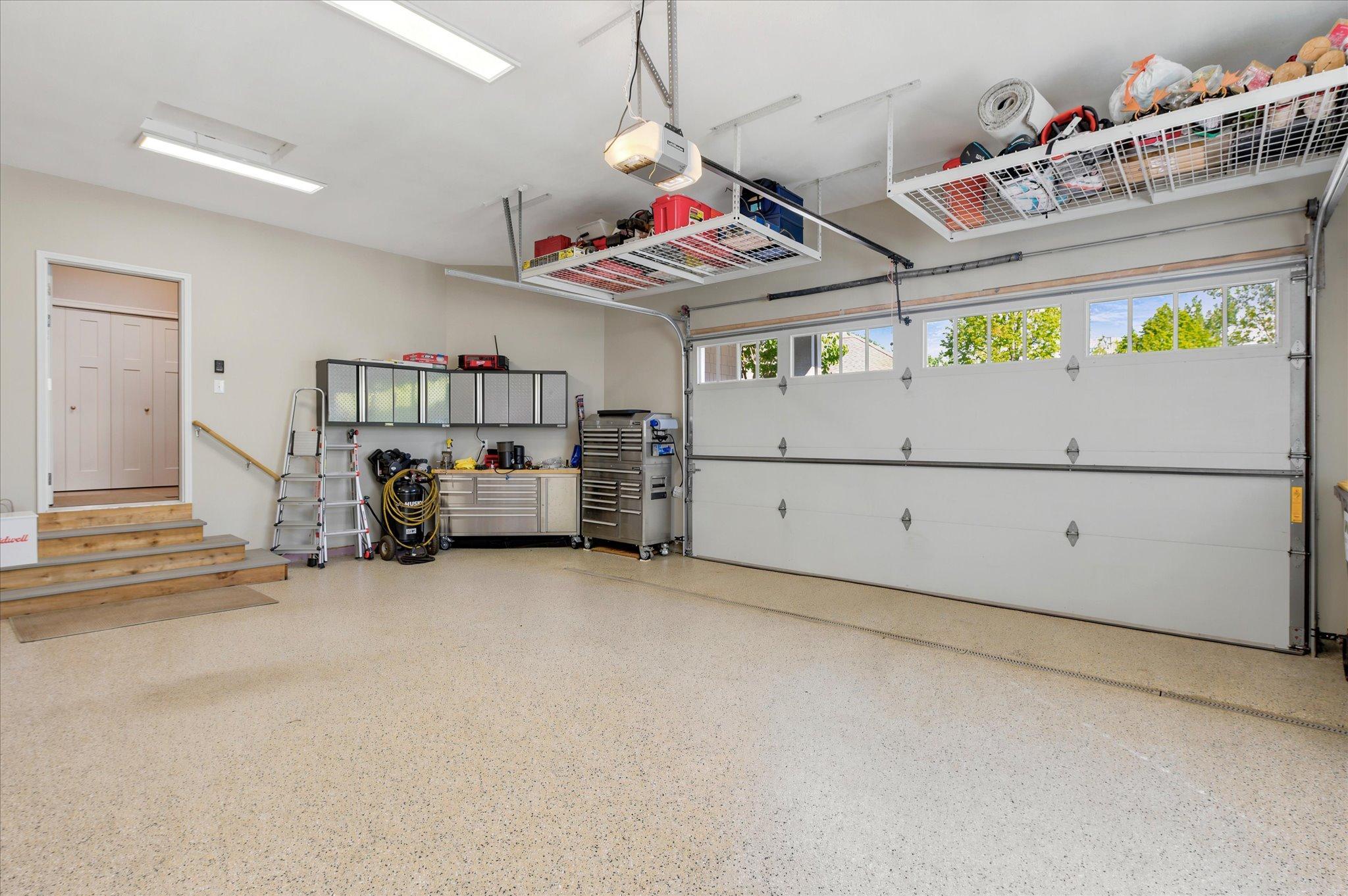 Drain in the floor. Overhead attached storage racks will stay with the home.