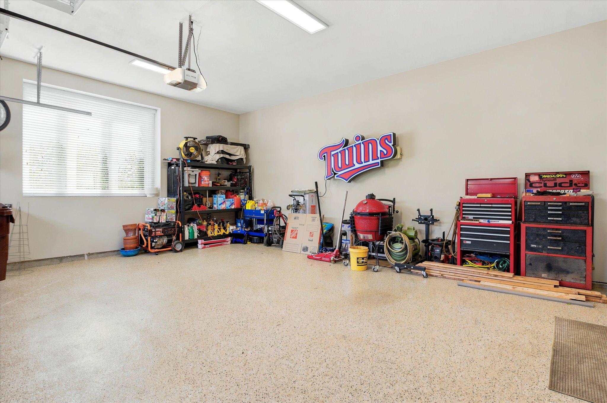 2 car garage with poly floors, insulated and sheet-rocked. Wired for electric vehicle and heat