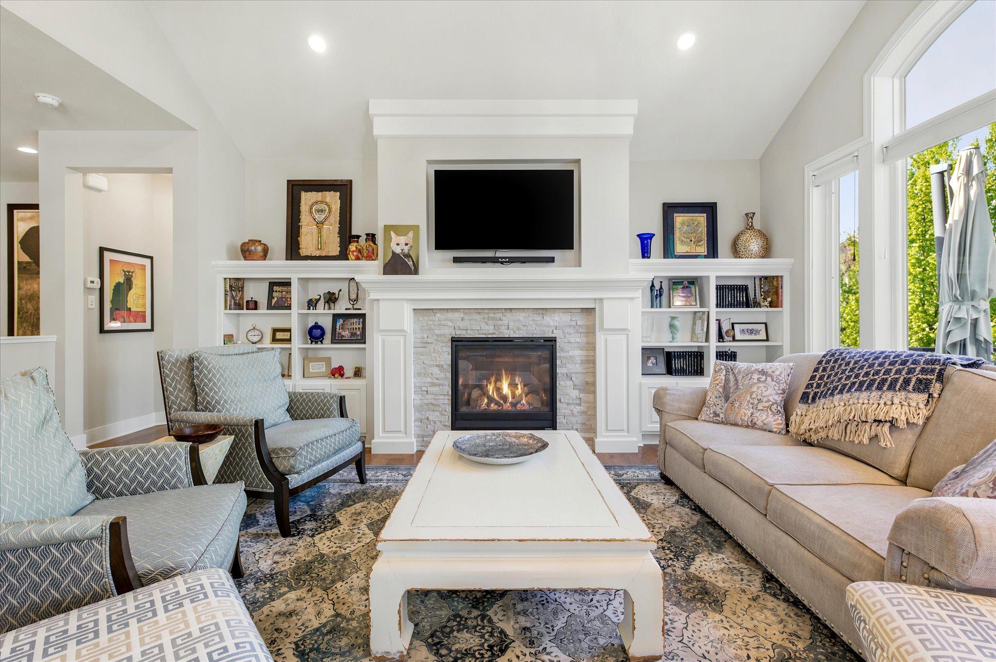Gas fireplace in the living room is surrounded by built-ins