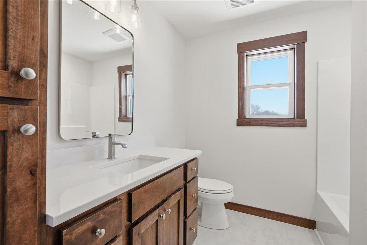 Full bath with continued dark wood and white accents!