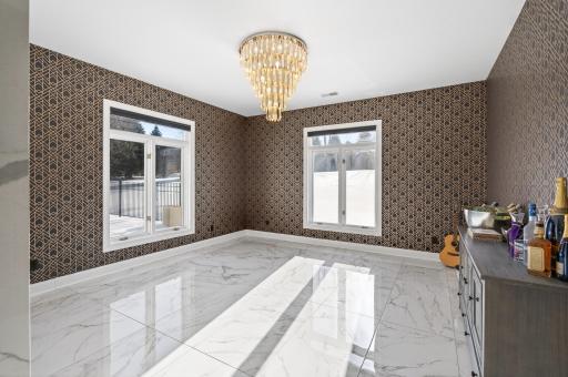 Adjacent to the family room, on the opposite side of a dramatic marble partition, is an inviting sitting area.