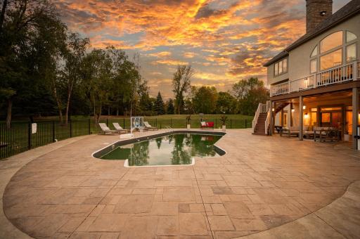 The exceptional backyard is designed for outdoor enjoyment, offering a fully fenced pool deck with an in-ground heated pool.