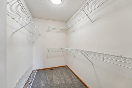 This large walk-in closet offers ample storage and organization space, making it easy to keep everything neatly tucked away while adding ease to your daily routine.