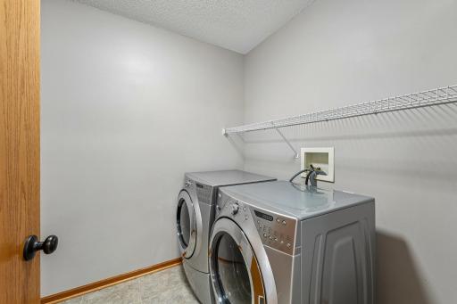 Second floor laundry featuring stainless steel washer and dryer