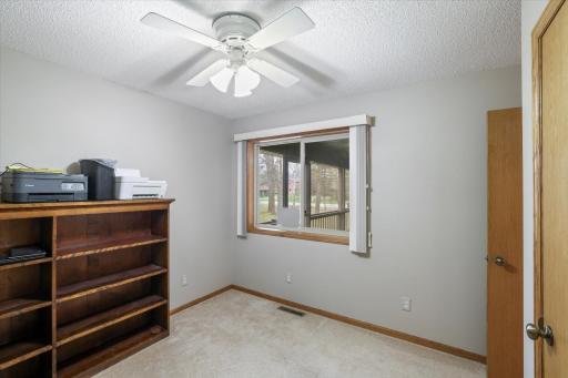 Bedroom 2 with ceiling fan, closet, and window
