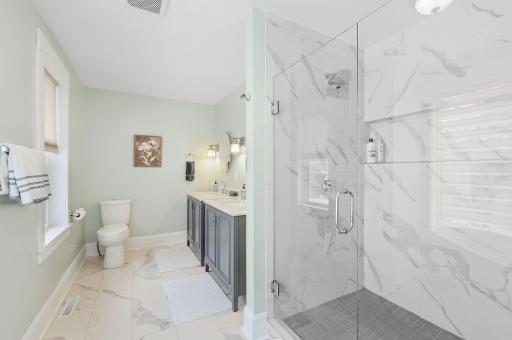 Big enough of for 2 is this 4x4 massive shower with accent tile floor & surround