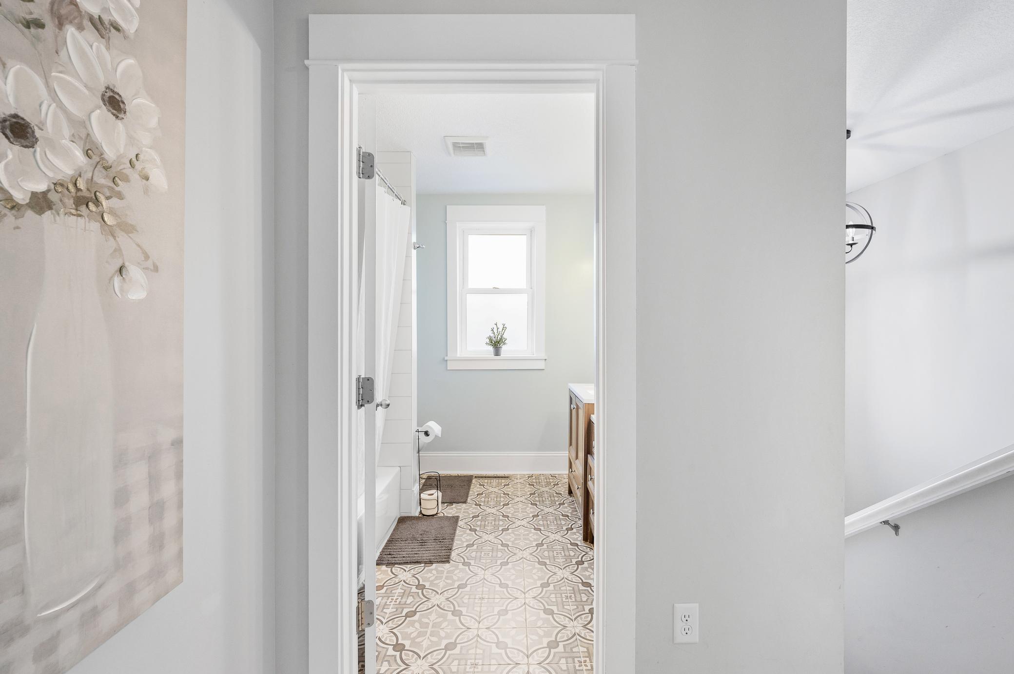 Full Size Hall Bath with Double Vanities and Unique Patterned Tile