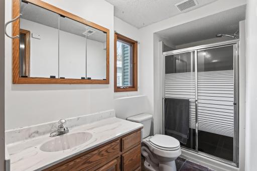 Convenient three-quarter bathroom featuring a practical layout and a clean, inviting design.