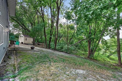 A wooded backyard creates a natural backdrop and a sense of privacy rarely found in neighborhood settings.