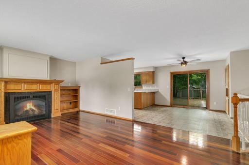 An open layout connects the living room, dining area, and kitchen.
