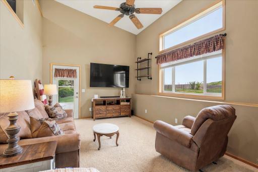 Walk down a few steps from the kitchen/dining area into the huge living room which walks out to the large concrete patio area.