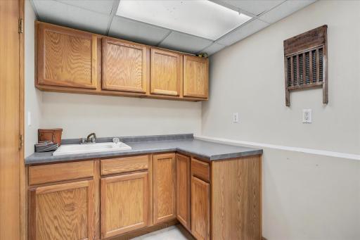 Laundry sink and tons of cabinetry for storage in the large laundry room. There is also a 4th level of the home which has a large 15x10 unfinished space perfect for extra storage needs or finish it off for more finished square footage.