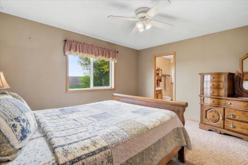 On the upper level of the home there is this primary ensuite with a private 3/4 bath and large walk in closet.