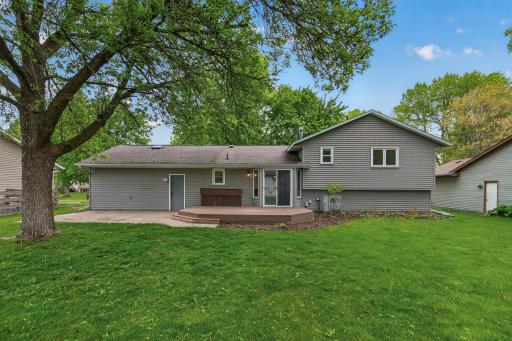 Rear exterior showcasing the spacious backyard and deck