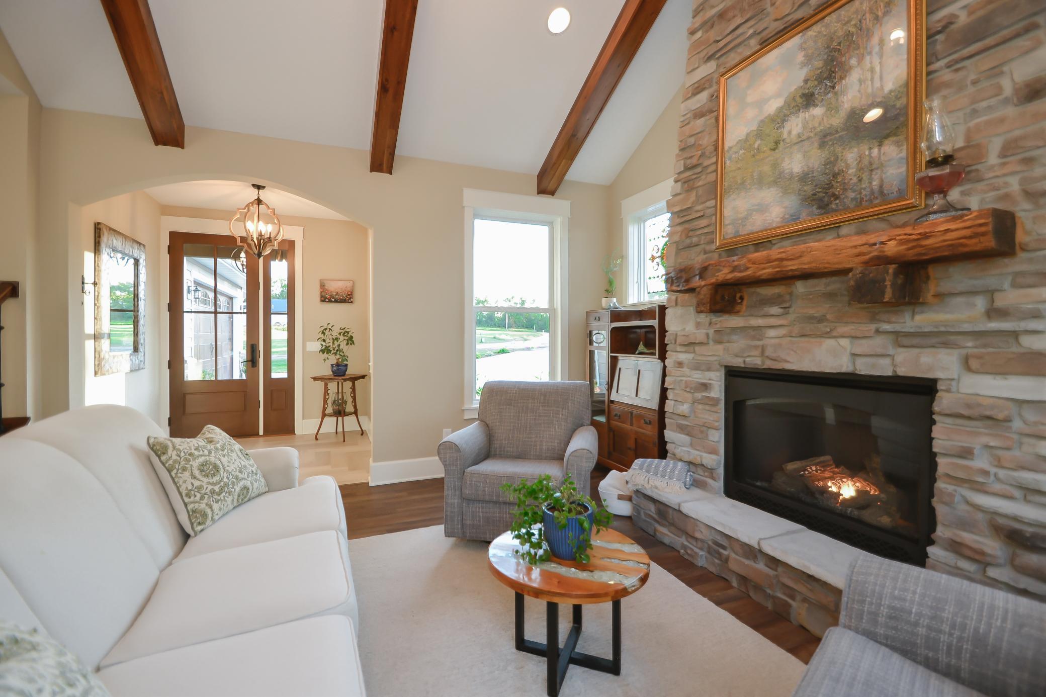 This year-round lakefront home features soaring cathedral vaulted ceilings, expansive Marvin windows, a stunning stone fireplace with reclaimed 1890s mantle, and an open concept layout designed for both entertaining and everyday comfort.