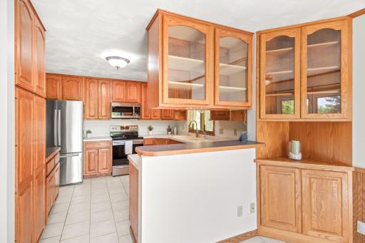 The kitchen flows seamlessly into the dining room with built-in cabinets and tons of charm.
