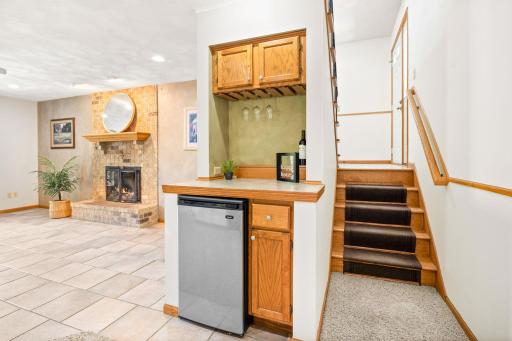 Downstairs offers a small built-in bar area with mini fridge.
