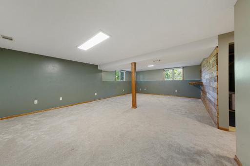 Large Family Room with knockdown ceiling, fully carpeted, and ample lighting