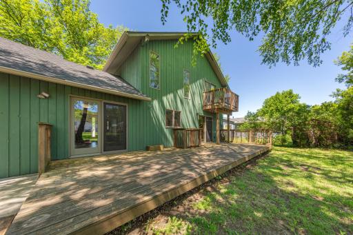 The primary bedroom features a small, private balconydeck!