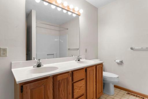 The primary bathroom has double sinks and a separate bathtub and shower.