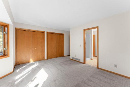 The primary bedroom features a wall of closets and walk through access to the bathroom.