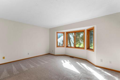 The primary bedroom has bay windows and views of the golf course.