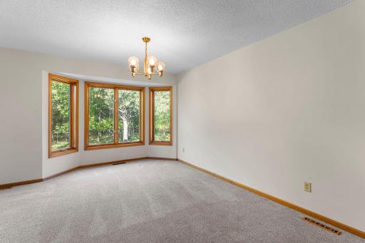 The oversized living room has a bay window and space for a dining table.