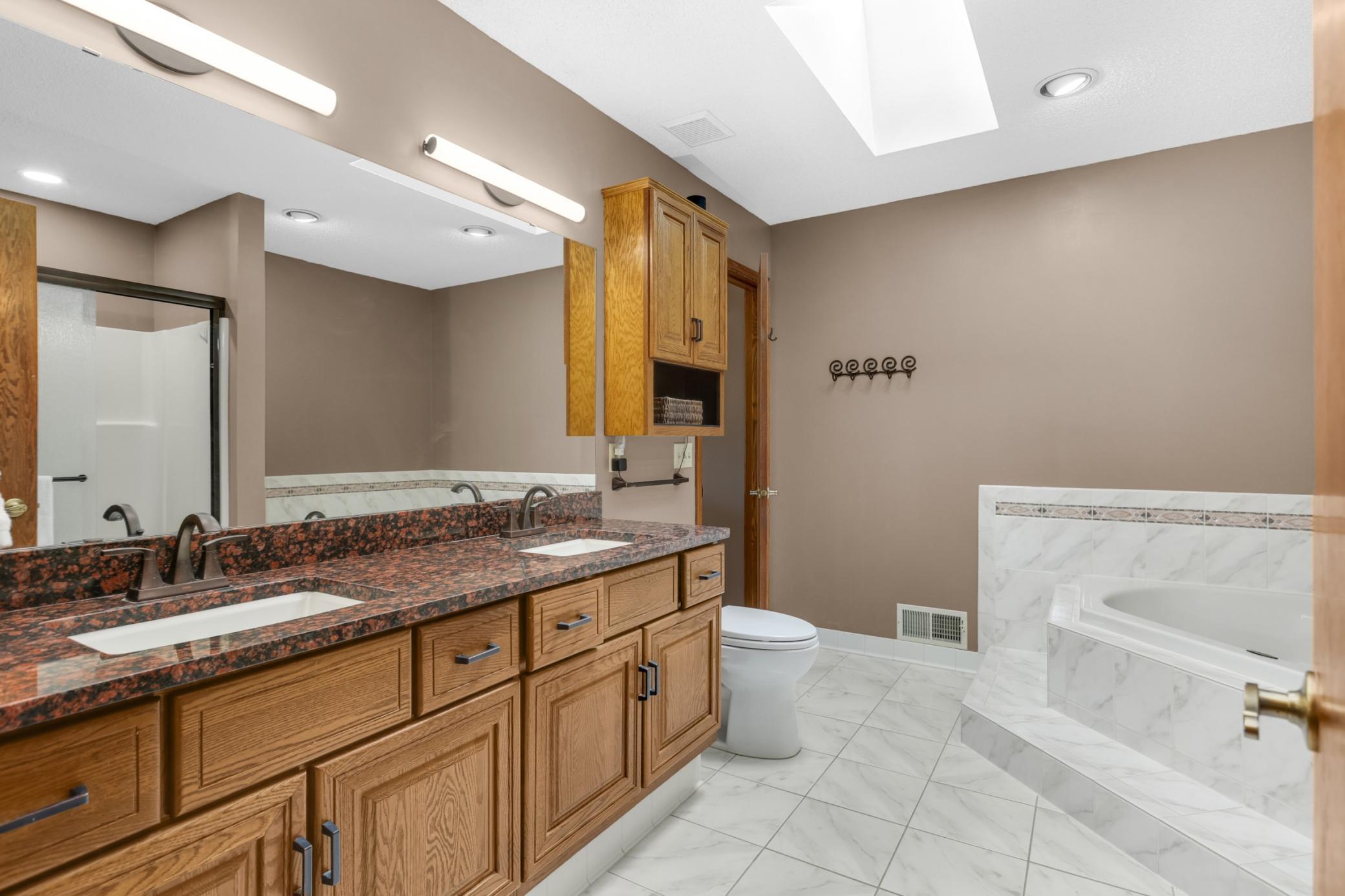 Upper level bath features separate tub and shower.
