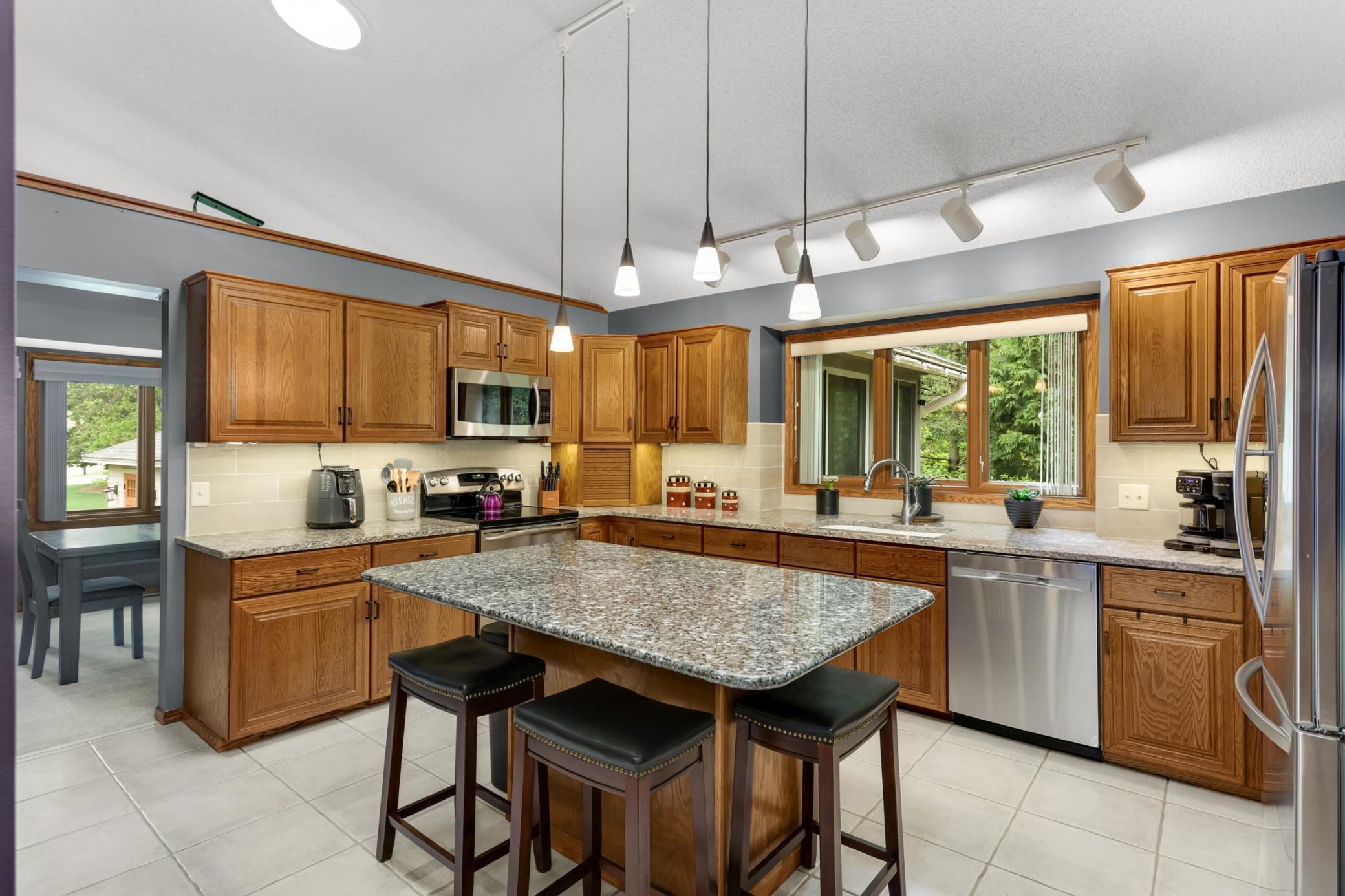 Kitchen feature large center island and granite counters.