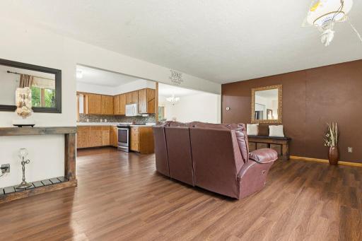 The front entry opens up to the living room, kitchen, and dining room