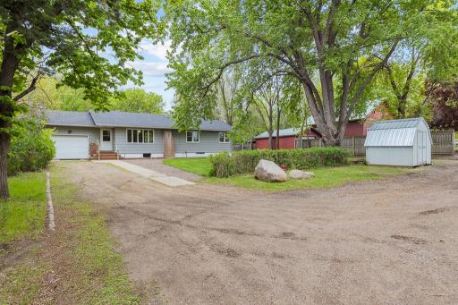 1 main driveway opening to garage and also a nice driveway area to S of shed in front.