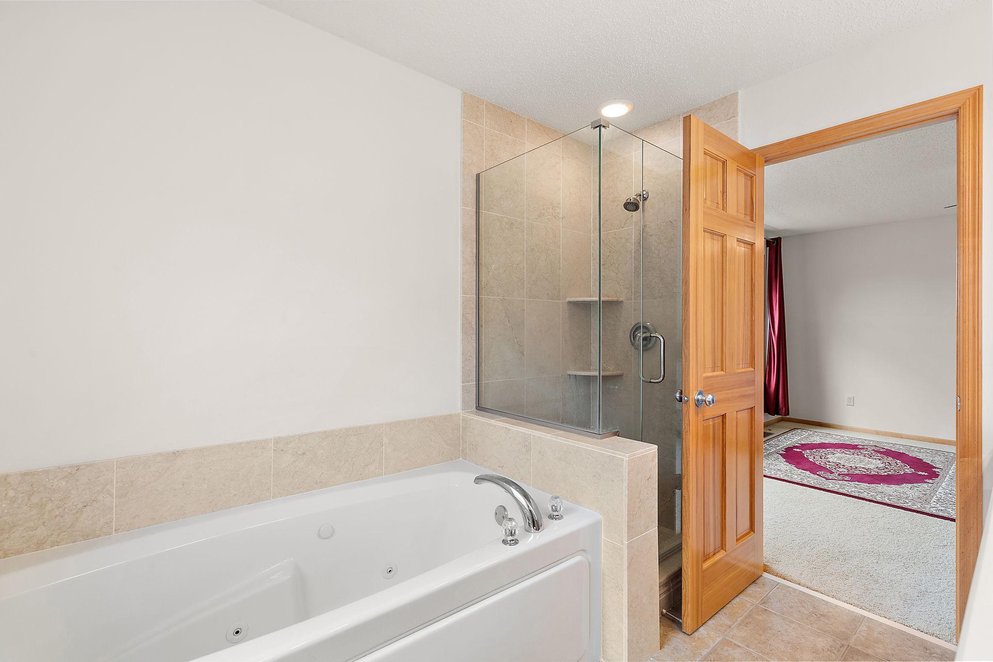 Primary full bath with dual vanity and separate tub/shower