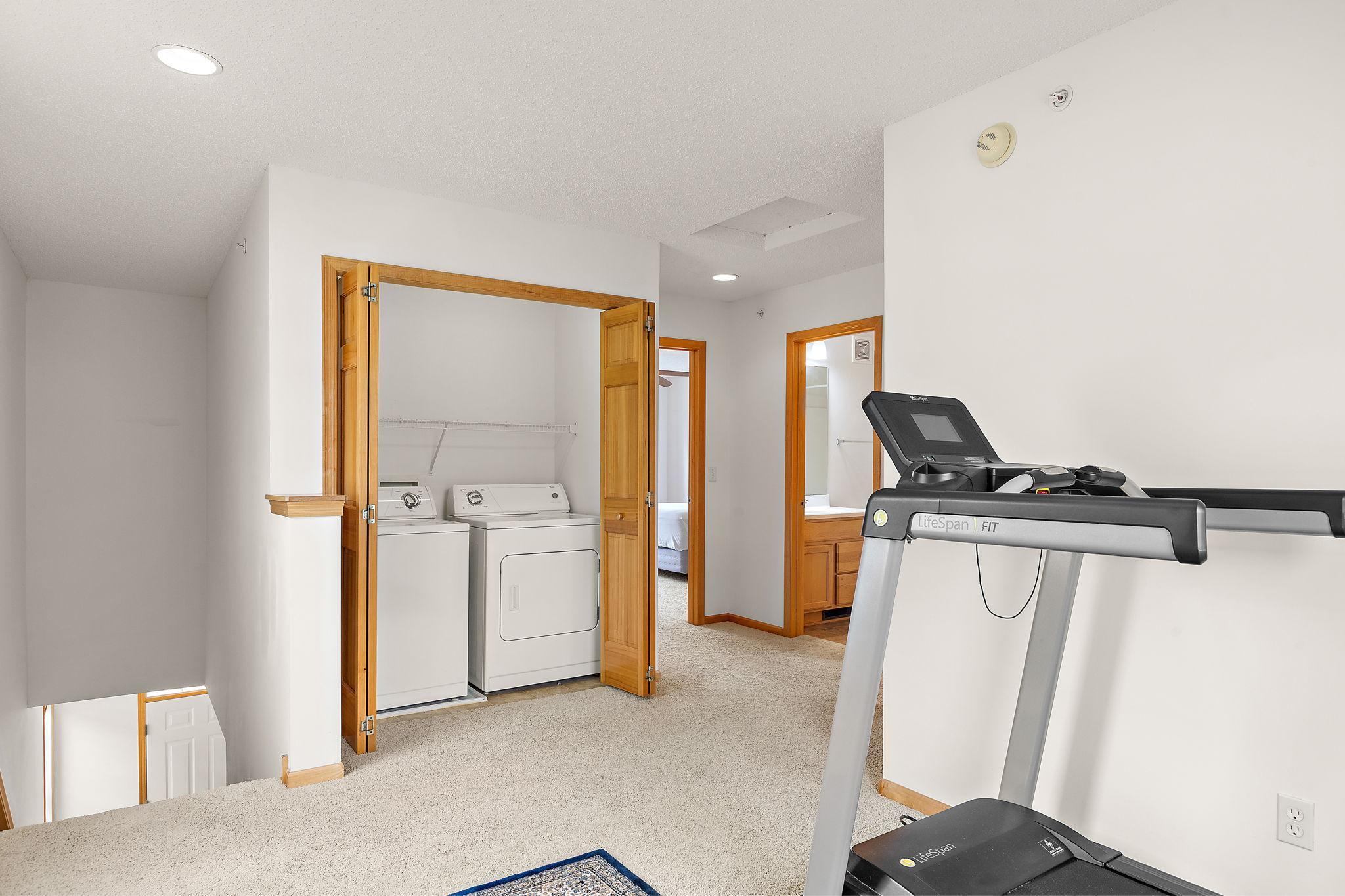 Upstairs loft area with in closet laundry