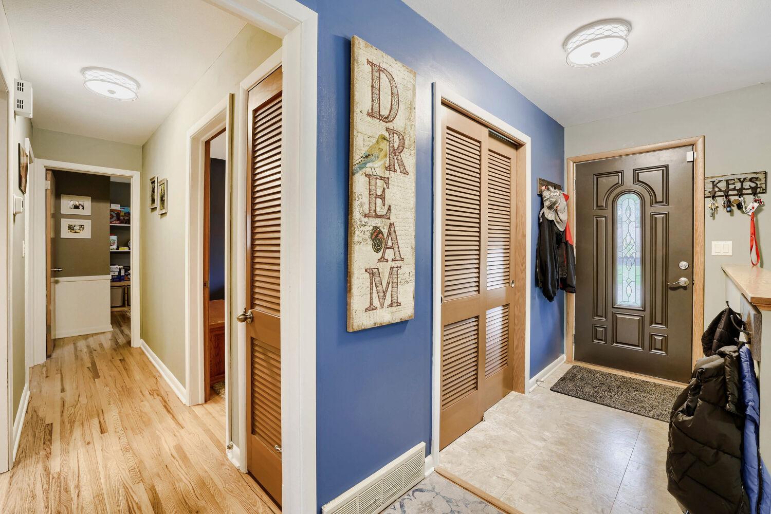 View of front door and hallway leading to bedrooms